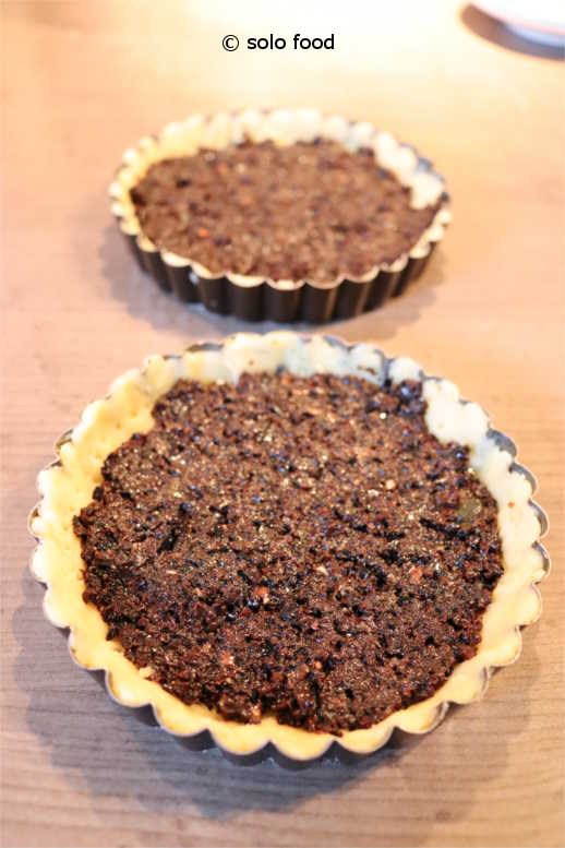 Tarts with cherry tomatoes and tapenade with black olives - with <em>tapenade</em>