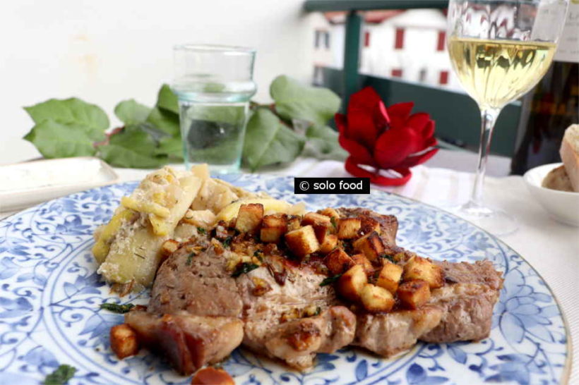 Pork chop with rosemary and garlicky-lemon croutons