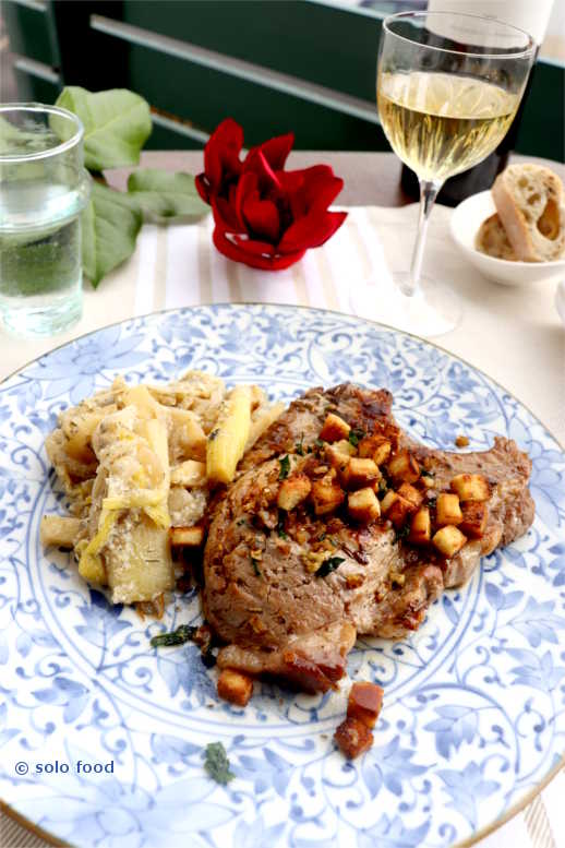Pork chop with rosemary and garlicky-lemon croutons